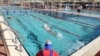 People swim at a pool where a 'Green Badge' is required to enter, as Israel reopens swathes of its economy, continuing to lift restrictions of a national lockdown to fight COVID-19, at Gordon Gym and Pool in Tel Aviv, Feb. 21, 2021.