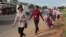Factory workers walk as they head for home after a day's work near Kantork village outside Phnom Penh, Cambodia, Monday, June 5, 2017. (AP Photo/Heng Sinith)