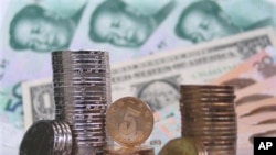 FILE - Coins, banknotes of Chinese yuan paired with a U.S. dollar during photo illustration, Fuyang, Anhui province, November 2006.