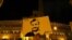 FILE - A man holds a placard during a vigil in memory of Giulio Regeni, who was found murdered in Cairo, Egypt, in January of 2016, in downtown Rome, Italy, Jan. 25, 2017.