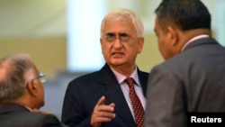 FILE - India's Foreign Minister Salman Khurshid speaks to his staff as they attend the 46th Association of Southeast Asian Nations (ASEAN) Foreign Ministers Meeting in Bandar Seri Begawan, July 1, 2013.