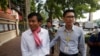 In this photo taken on Oct. 3, 2019, journalists Uon Chhin, left, and Yeang Sothearin arrive at the municipal court, in Phnom Penh. A Cambodian court has ordered a new investigation and postponed a verdict in the espionage trial of the two journalists.