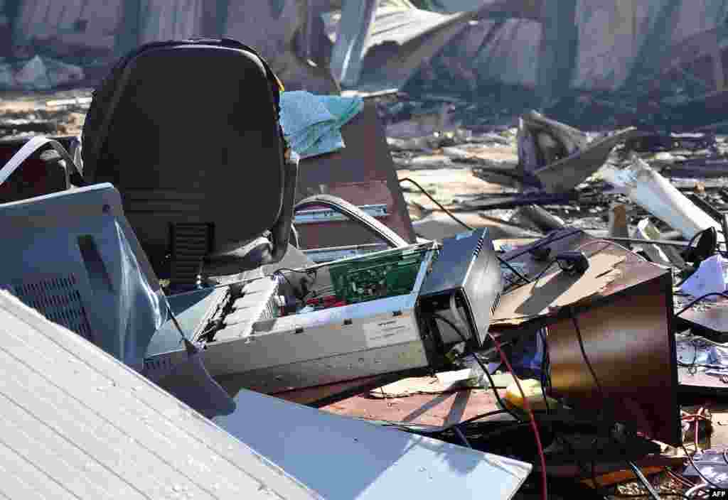 Damaged equipment at the site of an attack on the pro-government al-Ikbariya satellite television channel&#39;s offices outside Damascus