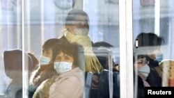 Passengers wear masks inside a trolley bus in Pyongyang, North Korea, in this photo taken February 22, 2020 and released by Kyodo February 23, 2020. Mandatory credit Kyodo/via REUTERS ATTENTION EDITORS - THIS IMAGE WAS PROVIDED BY A THIRD PARTY…