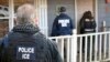 FILE - In this Feb. 9, 2017, photo provided U.S. Immigration and Customs Enforcement, ICE agents are at a home in Atlanta, Georgia, during a targeted enforcement operation aimed at immigration fugitives, re-entrants and at-large criminal aliens.