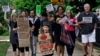 FILE - Jackson Borrello, 8, leads activists with a Tuesdays with Tillis rally outside U.S. Senator Tom Tillis' office at the Federal Building to demand the reunification of families separated at the border in Raleigh, N.C., June 26, 2018.