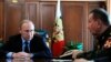 FILE - Russian President Vladimir Putin, left, and Commander-in-Chief of the Interior Ministry troops Viktor Zolotov attend a meeting in the Kremlin in Moscow, Russia, April 5, 2016.