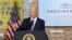 FILE - President Joe Biden gestures as he delivers remarks on the importance of COVID-19 vaccine requirements, during a visit at a Clayco construction site, in Elk Grove Village, Illinois, Oct. 7, 2021. 
