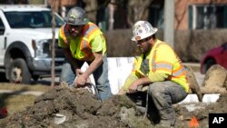 FILE - Construction workers work in Mount Prospect, Illinois, on Feb. 26, 2024. U.S. employers added 303,000 workers to their payrolls in March, the Labor Department reported on April 5, 2024.