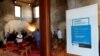 A health advisory poster is seen during a wedding ceremony with limited number of guests, standing one meter away from each other, as Italy struggles to combat a coronavirus outbreak, at the Caracalla wedding venue in Rome, Italy March 7, 2020.