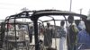 Residents survey vehicles damaged after a bomb blast at a primary school in Maiduguri, the capital of Nigeria's Borno state, February 29, 2012. 