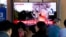 People watch a TV showing a file image of North Korea's missile launch during a news program at the Seoul Railway Station in Seoul, South Korea, Oct. 2, 2019.