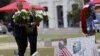 President Barack Obama, left, and Vice President Joe Biden place flowers at a makeshift memorial for shooting victims of the massacre at a gay nightclub in Orlando, Fla., June 16, 2016. 