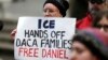 FILE - In Feb. 17, 2017, photo, a protester stands in Seattle. A federal judge upheld a decision not to release Daniel Ramirez Medina, a Mexican arrested near Seattle, despite his participation in the DACA program.