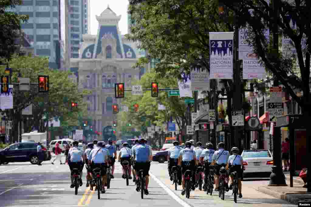 Police ride bicycles down Market Street toward City Hall ahead of the Democratic National Convention in Philadelphia, July 24, 2016.