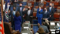 In this image from video, Vice President Kamala Harris swears in Sen. Raphael Warnock, D-Ga., Sen. Alex Padilla, D-Calif., and Sen. Jon Ossoff, D-Ga., on the floor of the Senate, on Capitol Hill in Washington, Jan. 6, 2021.