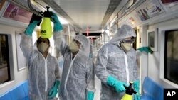 Workers disinfect subway trains against coronavirus in Tehran, Iran, in the early morning of Wednesday, Feb. 26, 2020. Iran's government said Tuesday that more than a dozen people had died nationwide from the new coronavirus, rejecting claims of a…