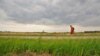Buddhist monk Sutham Nateetong walks along the road outside Arcola, IN. June 8, 2019.