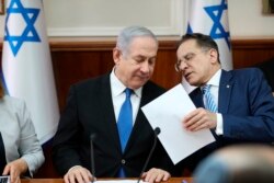 FILE - Israeli Prime Minister Benjamin Netanyahu, left, and Cabinet Secretary Tzahi Braverman attend the weekly Cabinet meeting at his office in Jerusalem, Dec. 1, 2019.