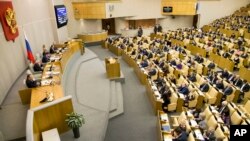 FILE - Russian lawmakers vote at the State Duma in Moscow, Russia, Jan. 27, 2017. The lower house of Russia's parliament wants to probe compliance of some U.S.-linked international broadcasters with Russian law.