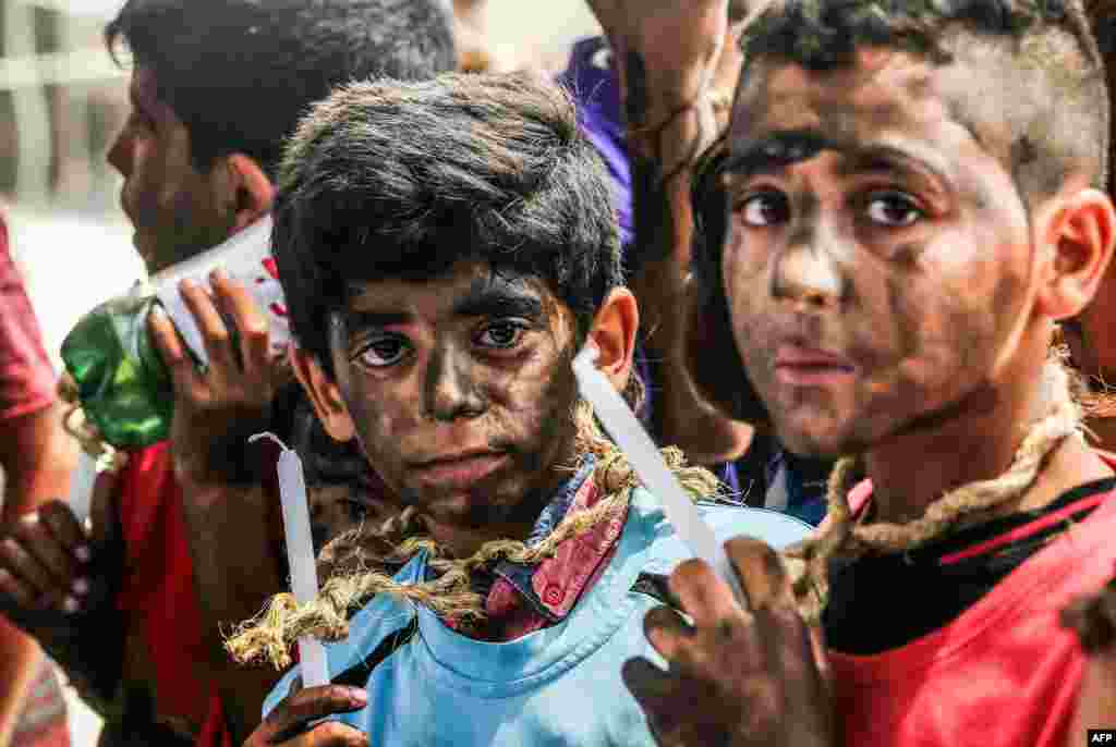 Palestinian children demonstrate against Israel's blockade on the enclave with candles at the Erez crossing with Israel near Beit Hanun in the northern Gaza Strip.