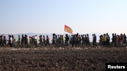 African migrant laborers stage a march to protest against their work conditions in Italy, following the death of 16 of their colleagues in two separate road accidents, near Foggia, Italy, Aug. 8, 2018. 