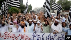Pakistani protesters shout slogans to condemn a cartoon contest by Dutch parliamentarian, in Lahore, Pakistan, Aug. 17, 2018. 