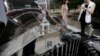 Visitors look around Rolls-Royce's vintage car during the Rolls-Royce's Concours d'Elegance event for celebrating its ten years of business in China, June 28, 2013. 