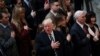President Donald Trump signs the National Anthem during a National Prayer Service at the National Cathedral, in Washington, Jan. 21, 2017. 