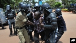 FILE - Critics say enforcement tactics by Uganda police are dictated by the government and are intended to intimidate the opposition. On March 28, 2012, police detained a supporter of opposition leader Kizza Besigye.