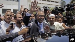 Makhdoom Shahabuddin, nominated prime minister by the ruling Pakistan People's party, waves after filing his papers in Islamabad, Pakistan, June 21, 2012.