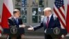 FILE - President Donald Trump and Polish President Andrzej Duda reach to shake hands at a news conference in the Rose Garden of the White House, in Washington, June 12, 2019.