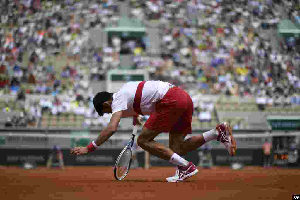 Serbia's Novak Djokovic stumbles during a point against Spain's Jaume Munar during their men's singles second-round match on day four of The Roland Garros 2018 French Open tennis tournament in Paris, France.