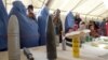 Afghan refugees family returning from Pakistan look at explosives and mines during an awareness program at the United Nations High Commissioner for Refugees registration center in Mommand Dara district in Jalalabad province, November 20, 2012.