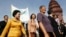 Sam Rainsy Party (SRP) members Chiv Kata, Thak Lany and Mu Sochua (L to R) walk during a protest in Phnom Penh, Cambodia, November 16, 2009. 