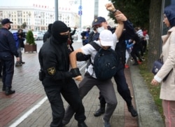 A student is detained by law enforcement officers during a protest against presidential election results in Minsk, Belarus, Sept. 1, 2020.