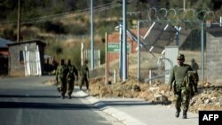 Soldiers walks inside the Makoanyane Barracks in Maseru, Leotho, Sep. 1, 2014.