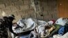 People suffering cholera symptoms rest on stretchers as they crowd the entrance of a public hospital in Limbe village near Cap Haitian, Haiti, 22 Nov 2010