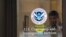 FILE - A security guard looks out of the U.S. Citizenship and Immigration Services offices in New York, Aug. 15, 2012.