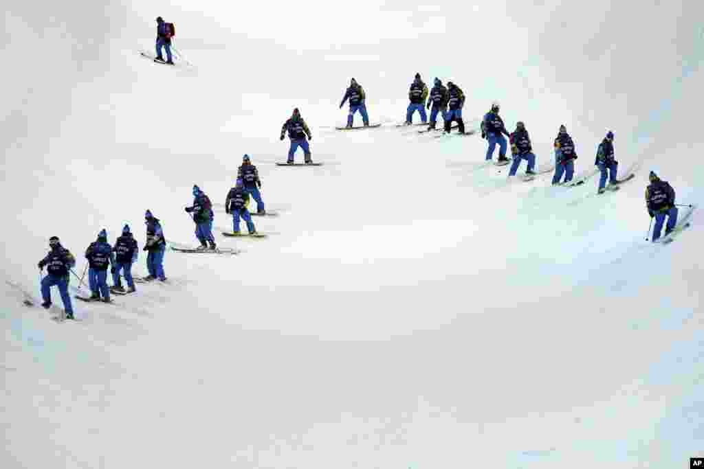 Volunteers check the condition of the half pipe at the Rosa Khutor Extreme Park,&nbsp;Krasnaya Polyana, Russia,&nbsp;Feb. 9, 2014.
