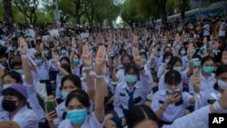 High school students flash the three-fingered salute, symbol of resistance, during a protest rally in Bangkok, Thailand, Sept. 5, 2020.