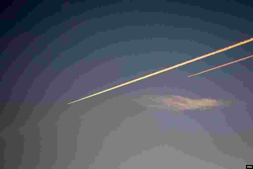 Two jets pass over, locals say these are the first non bomber planes they have seen in almost three years. (Adam Bailes/VOA News)