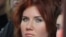 In this Sunday, Oct. 30, 2011 photo Anna Chapman, who was deported from the U.S. on charges of espionage, seen during the displaying of creation by Russian designer Ilia Shiyan at the Volvo Fashion Week Moscow, Russia. A year and a half after the biggest 