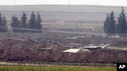 Turkish forces artillery pieces are seen on their new positions near the border with Syria in Sanliurfa province, Turkey. U.S.-backed Kurdish-led forces in Syria said American troops began withdrawing Monday from their positions, Oct. 6, 2019.