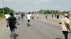 A screen grab shows people running during a protest in Abuja, Nigeria, Sept. 28, 2021. 