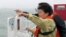 South Korean President Park Geun-hye looks at the site where the Sewol sank from aboard a Coast Guard ship in waters off the southern coast near Jindo, South Korea, Thursday, April 17, 2014.
