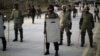 Pakistani rangers stand guard as supporters of cleric Tahir-ul Qadri attend a rally in Islamabad, Jan. 14, 2013.