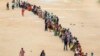 Hundreds of people line up to receive their second dose of vaccine against the coronavirus at the municipal ground in Hyderabad, India, Thursday, July 29, 2021.