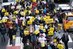 FILE - Restaurant and bar owners, employees and union workers march on 42nd Street in support of the restaurant industry, Dec. 15, 2020, in New York.