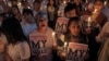 Members of the "White Shirt" movement hold a candlelight vigil to demand democratic elections and political reforms in Bangkok, Thailand, Jan. 24, 2014. 